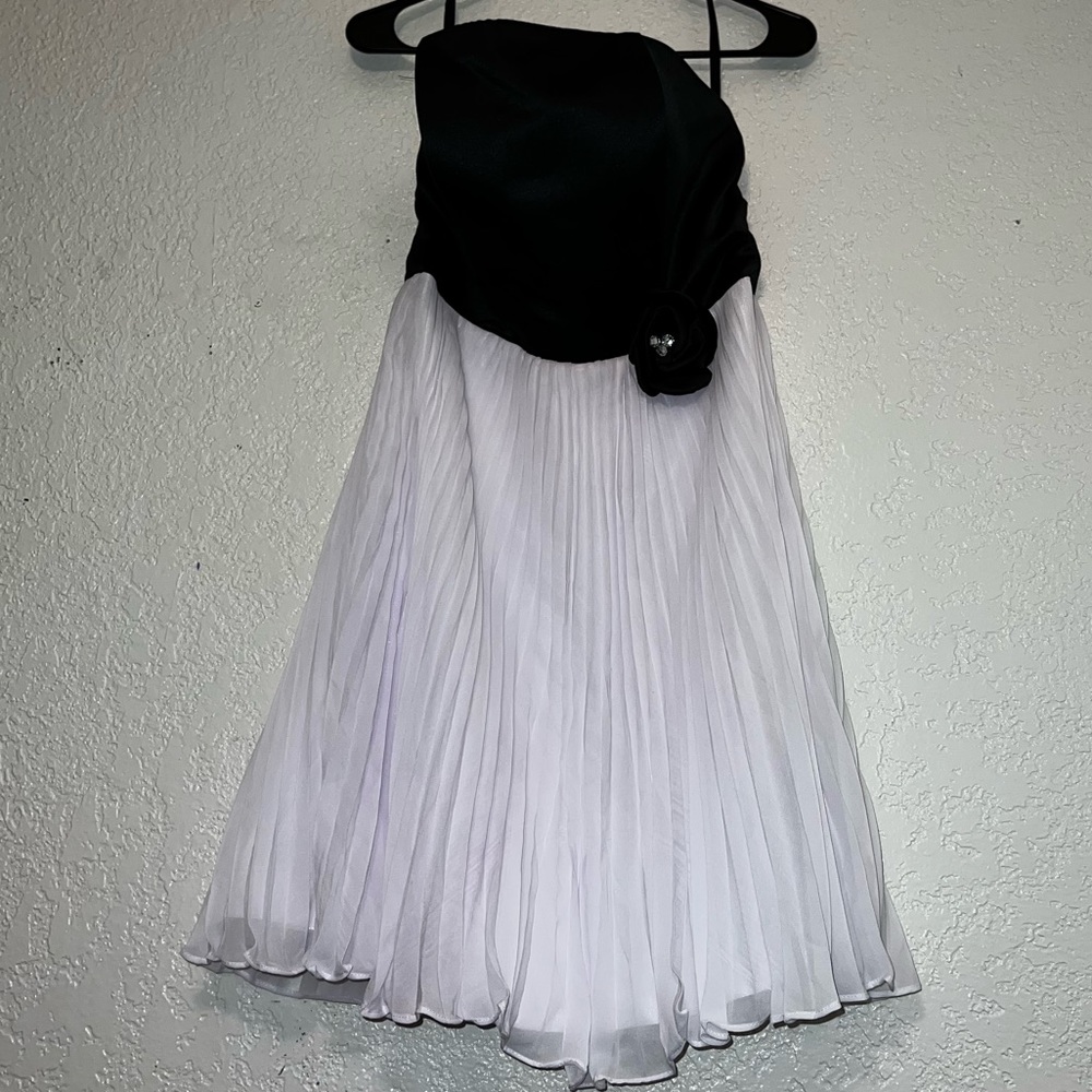 Strapless semi formal black and white dress with rhinestone flower.